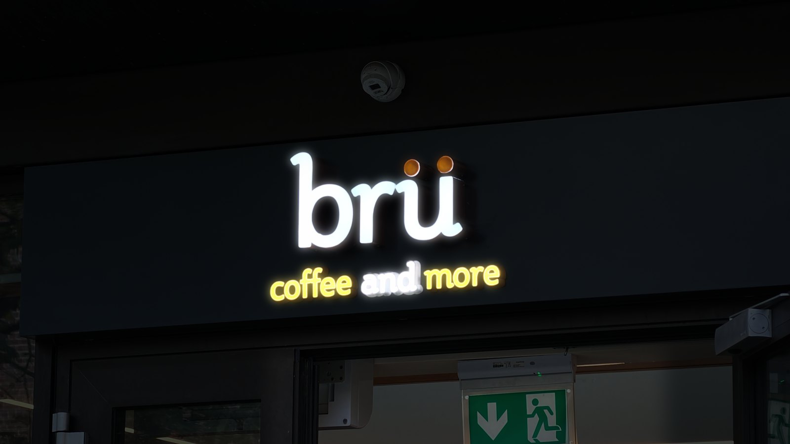 brü coffee and more sign lit in white and orange