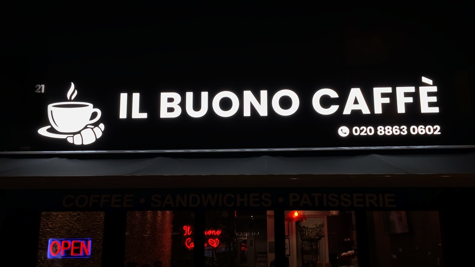 Il Buono Caffè illuminated letters and cup logo at night