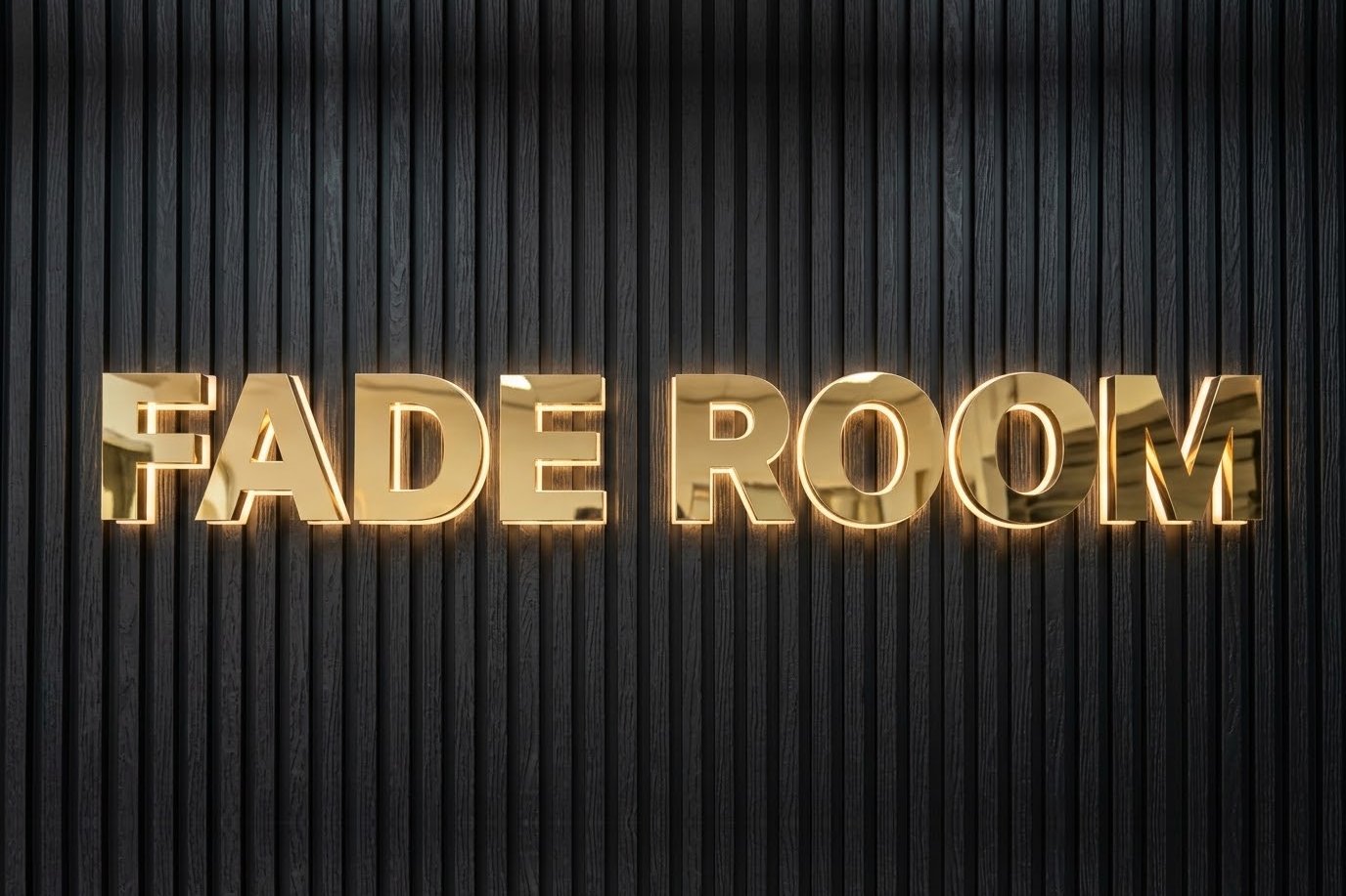 Gold mirror halo-lit letters reading FADE ROOM on a black fluted wall