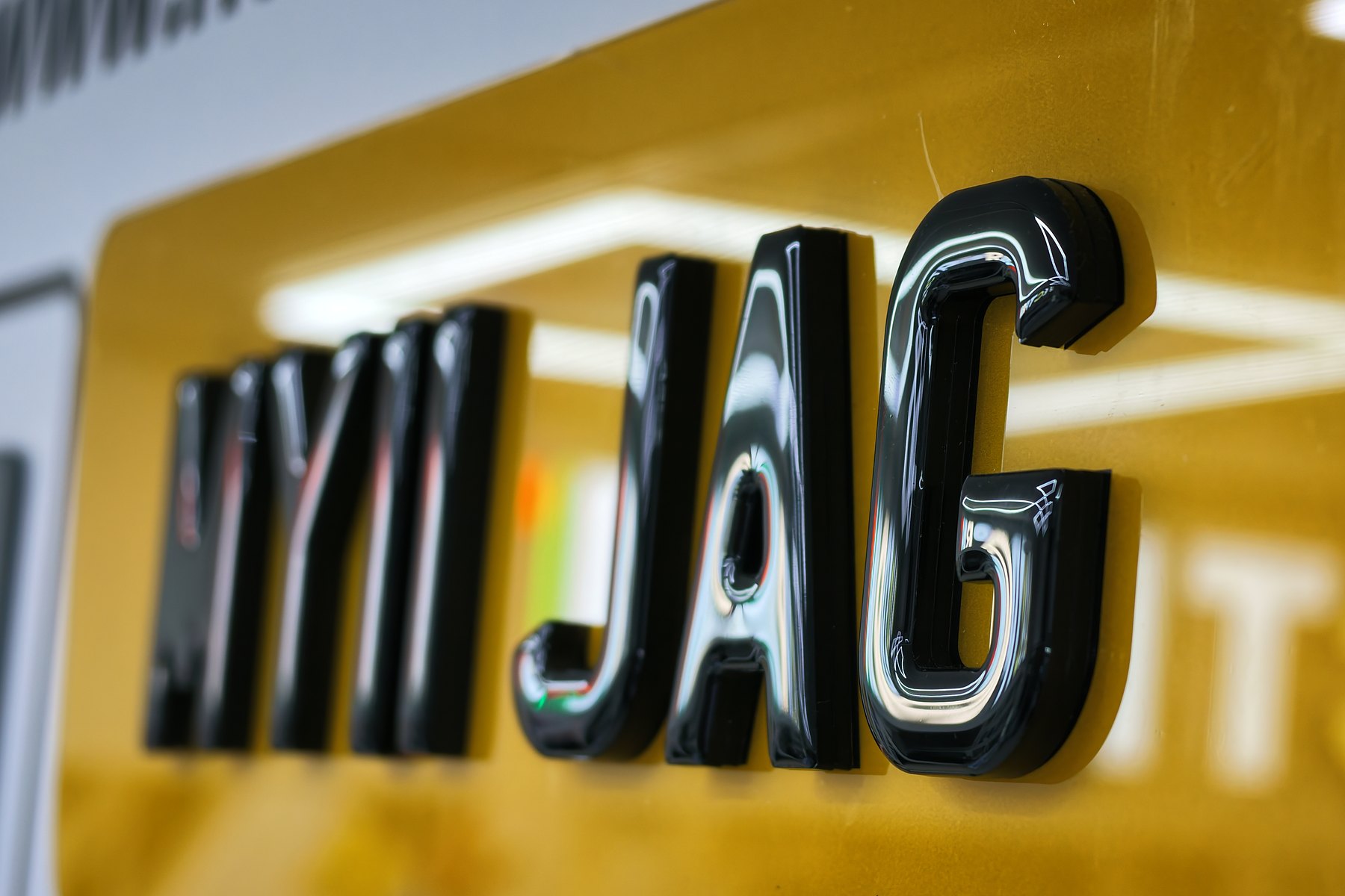 Glossy 3D gel raised letters on a yellow number plate