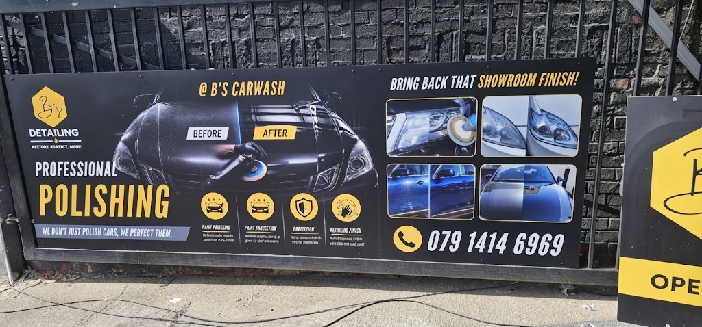 Printed boards we made for B’s Carwash, fixed to a fence